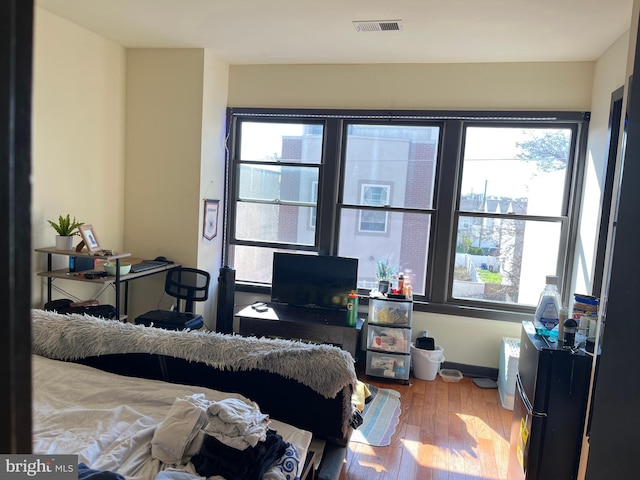 bedroom with wood finished floors and visible vents