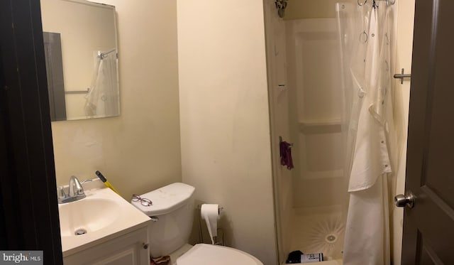 full bath featuring toilet, a shower stall, and vanity
