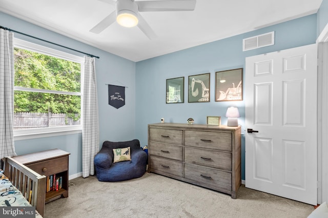 bedroom with visible vents, a ceiling fan, baseboards, and light carpet