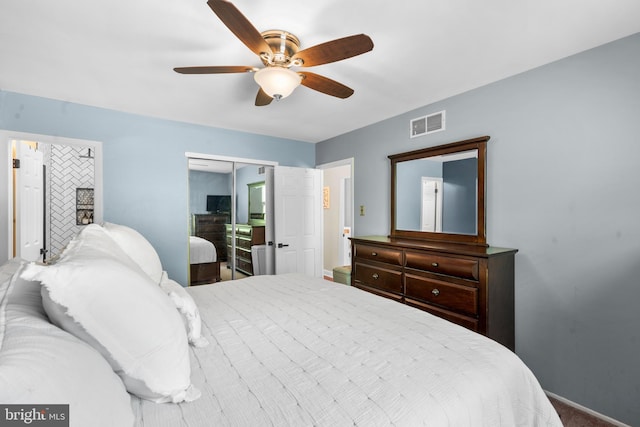 carpeted bedroom featuring baseboards, a ceiling fan, a closet, and visible vents