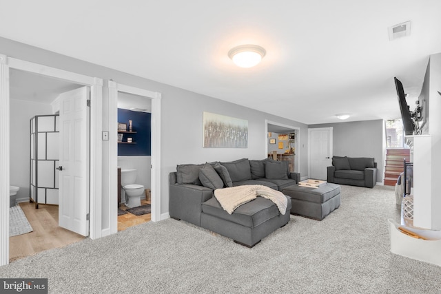 carpeted living area with visible vents