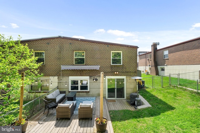rear view of house featuring a yard, an outdoor living space, a wooden deck, and a fenced backyard
