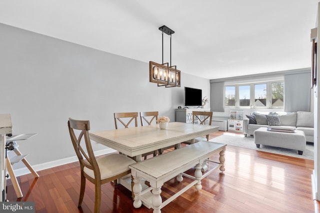 dining room with an inviting chandelier and wood finished floors