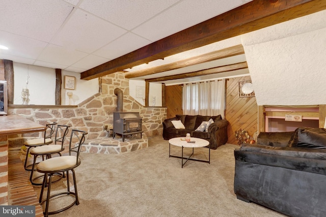 38 Bonniefield Cir, Gettysburg, PA 17325 - carpeted living area with a wood stove, wood walls, and beam ceiling