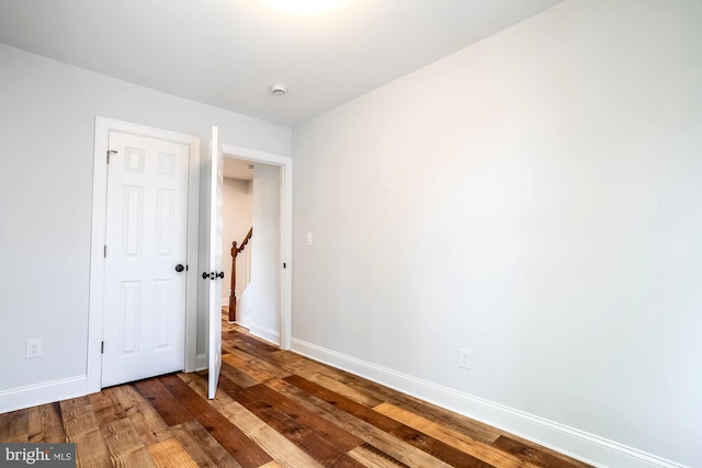interior space with baseboards and hardwood / wood-style floors
