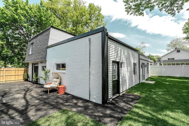 view of outbuilding featuring fence