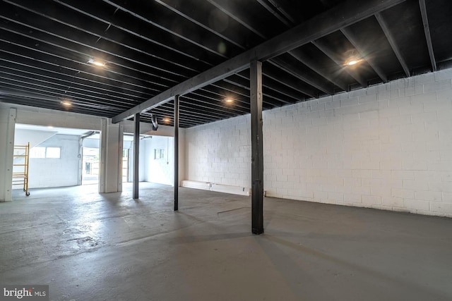 below grade area featuring concrete block wall