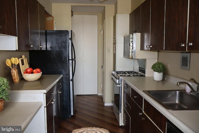 3600 Conshohocken Ave Unit 1004, Philadelphia, PA 19131 - kitchen featuring dark brown cabinetry, dark wood-style flooring, appliances with stainless steel finishes, a sink, and light countertops