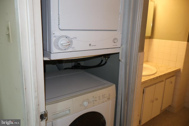 washroom with stacked washer and dryer