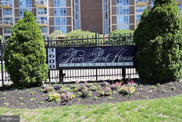 community sign featuring fence