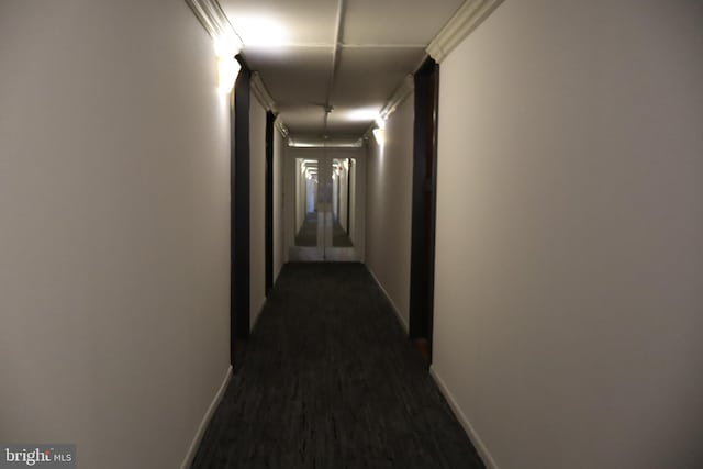hallway with baseboards and dark wood-style floors