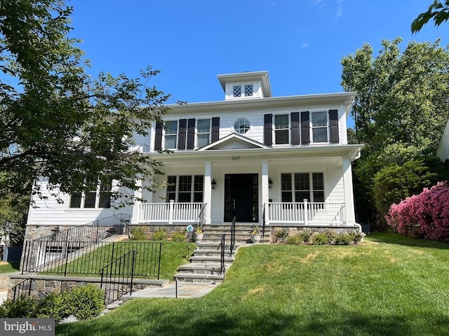 view of front of home featuring a porch, stairway, and a front yard