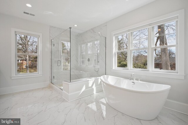 full bath with a freestanding bath, a marble finish shower, marble finish floor, baseboards, and visible vents