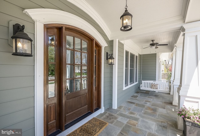 entrance to property featuring ceiling fan and covered porch