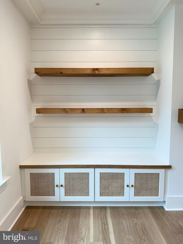 mudroom featuring baseboards, french doors, crown molding, and wood finished floors