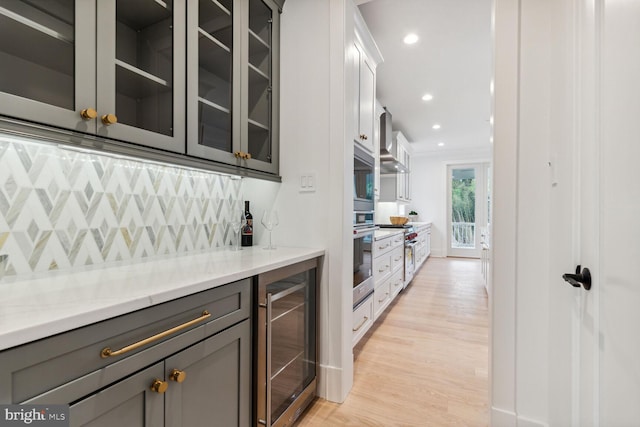 bar with recessed lighting, decorative backsplash, light wood-style flooring, and wine cooler