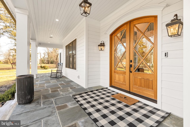 view of exterior entry featuring a porch