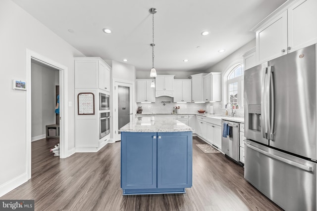 24083 Woodmore Dr, Hollywood, MD 20636 - kitchen with decorative backsplash, a kitchen island, white cabinets, stainless steel appliances, and dark wood-type flooring