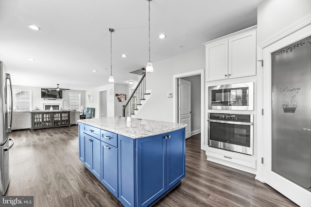 24083 Woodmore Dr, Hollywood, MD 20636 - kitchen featuring dark wood-type flooring, open floor plan, appliances with stainless steel finishes, and blue cabinetry