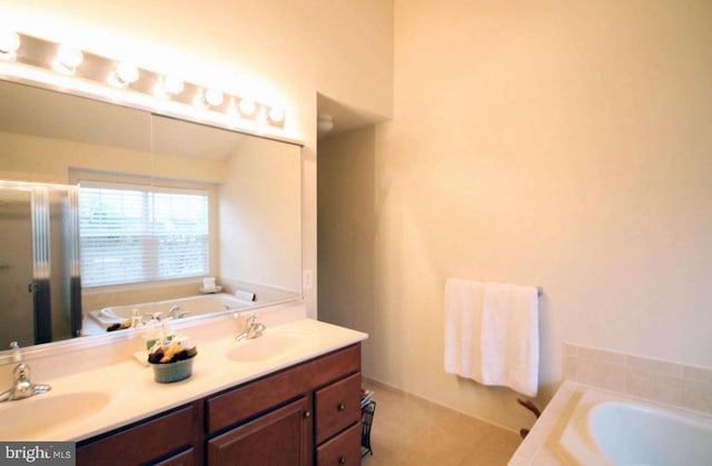 full bathroom featuring a garden tub, a sink, a stall shower, and double vanity