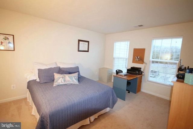 carpeted bedroom featuring baseboards and visible vents