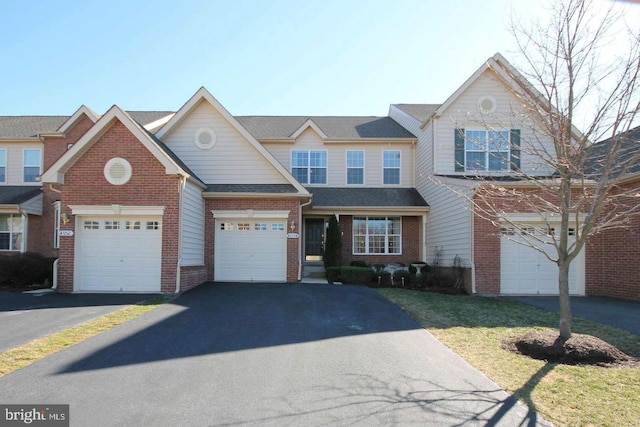 view of front facade featuring driveway and brick siding