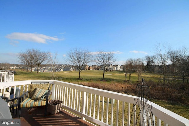 wooden deck featuring a lawn