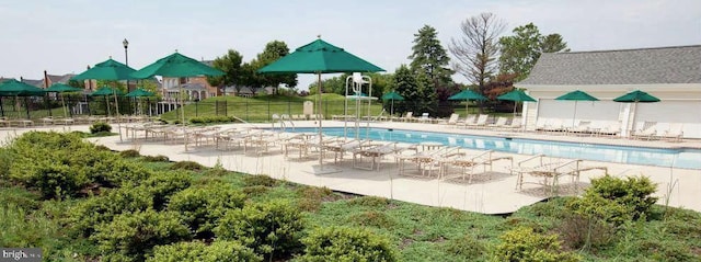 community pool with fence and a patio area