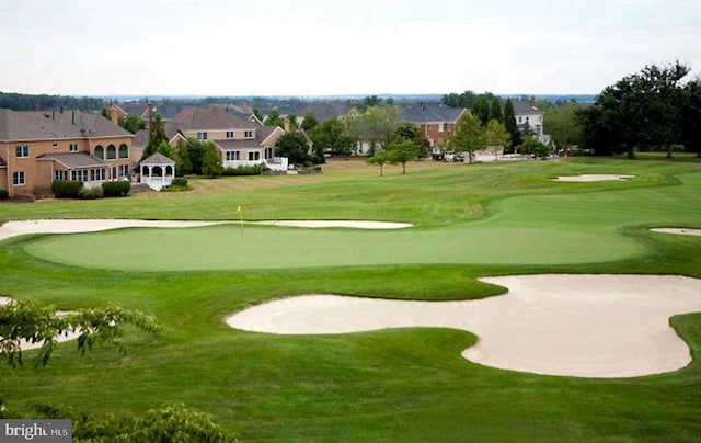 surrounding community featuring a yard and view of golf course