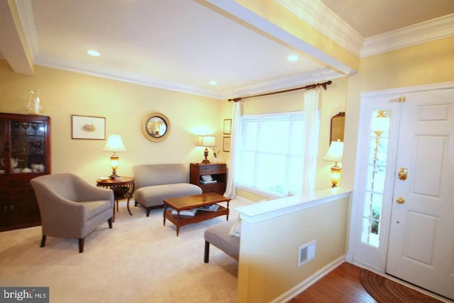 foyer entrance with ornamental molding, recessed lighting, and visible vents