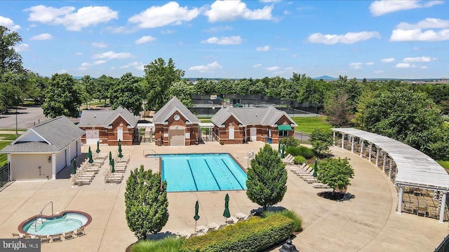community pool with fence and a patio area