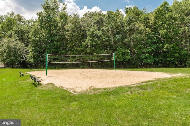 view of property's community with volleyball court and a lawn
