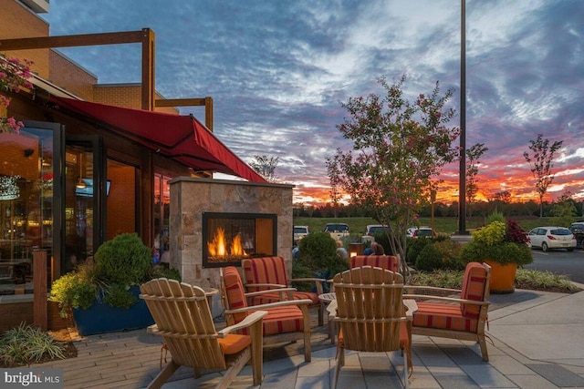patio terrace at dusk with a lit fireplace