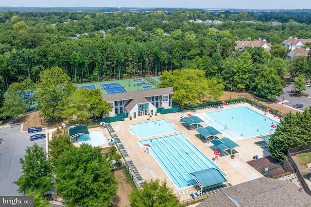 birds eye view of property featuring a wooded view