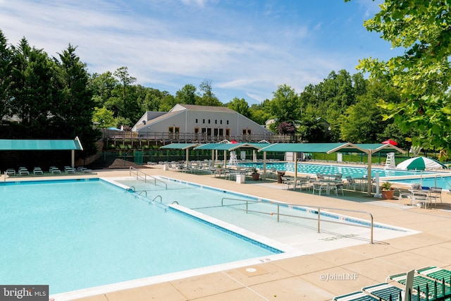 community pool featuring a water slide and fence