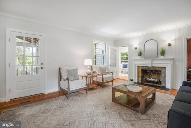 9709 W Bexhill Dr, Kensington, MD 20895 - living area with visible vents, ornamental molding, wood finished floors, and a fireplace