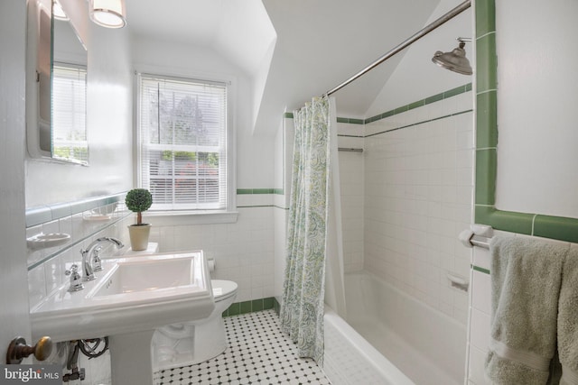9709 W Bexhill Dr, Kensington, MD 20895 - full bathroom with lofted ceiling, shower / bath combination with curtain, toilet, tile walls, and a wainscoted wall