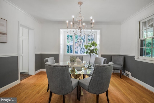 9709 W Bexhill Dr, Kensington, MD 20895 - dining space with visible vents, light wood-type flooring, crown molding, and an inviting chandelier