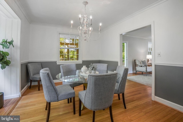 9709 W Bexhill Dr, Kensington, MD 20895 - dining space with baseboards, a notable chandelier, ornamental molding, and wood finished floors