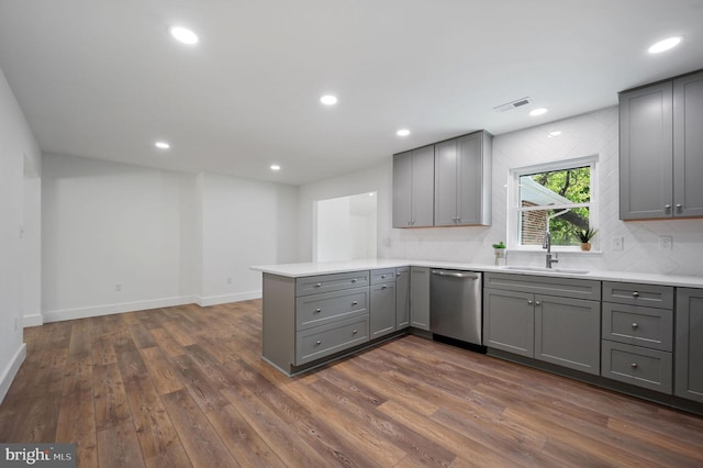 kitchen with gray cabinets, dark wood finished floors, visible vents, and dishwasher