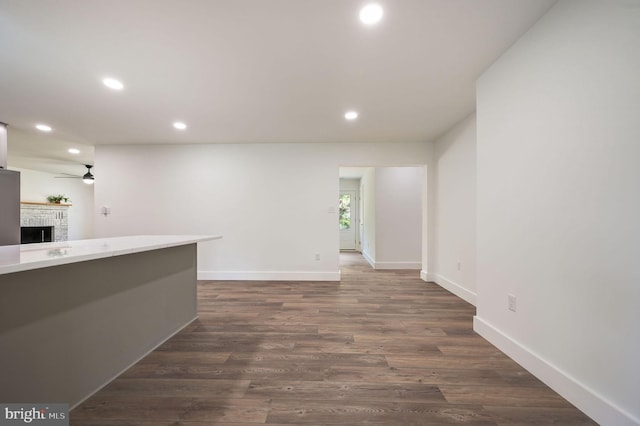 interior space featuring recessed lighting, ceiling fan, baseboards, and a fireplace