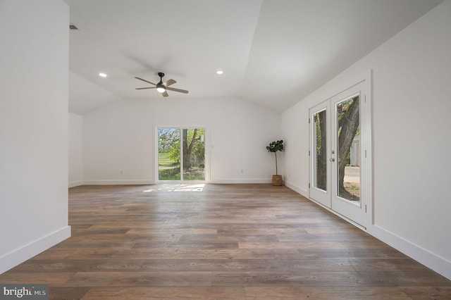 empty room with baseboards, a ceiling fan, wood finished floors, and lofted ceiling