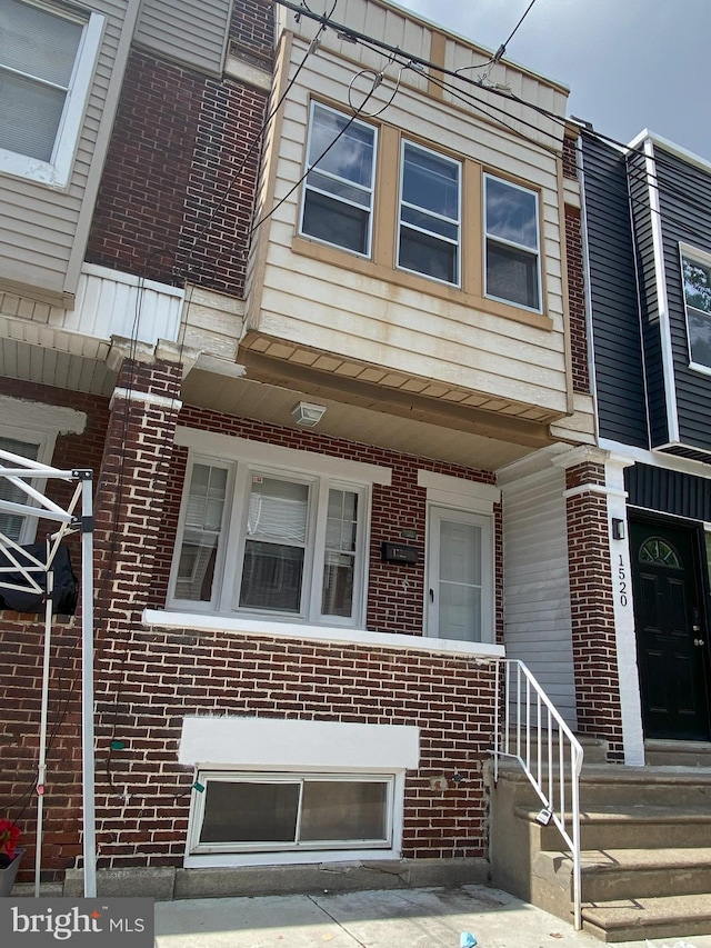 townhome / multi-family property featuring brick siding