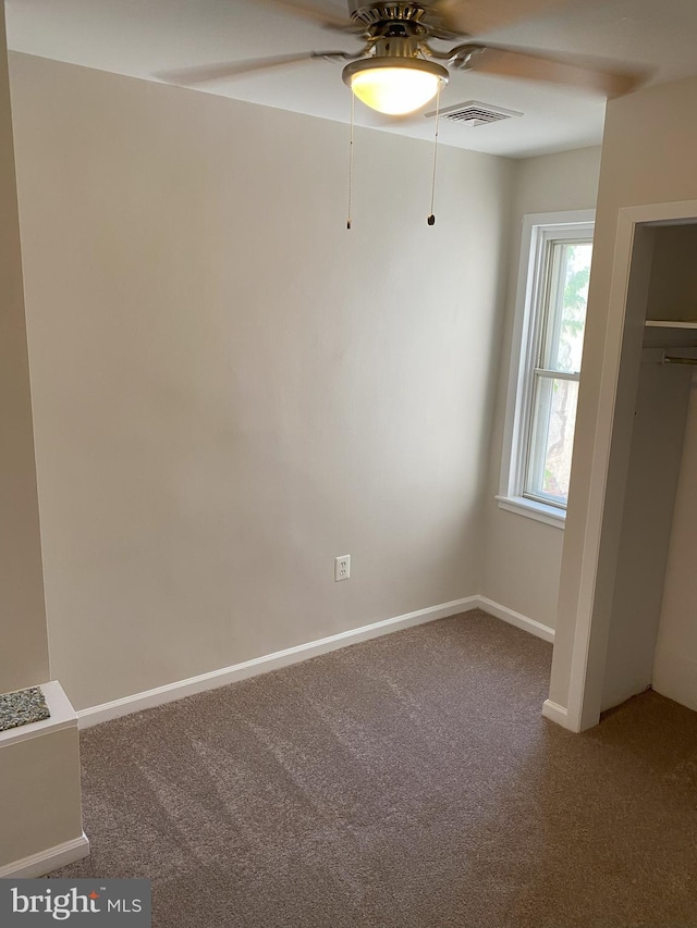 interior space with visible vents, carpet, ceiling fan, and baseboards