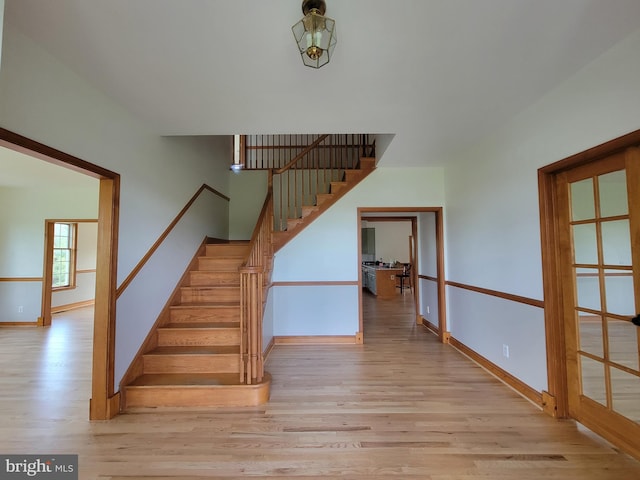 stairway featuring baseboards and wood finished floors