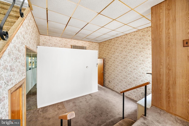 interior space featuring carpet floors, wallpapered walls, and visible vents