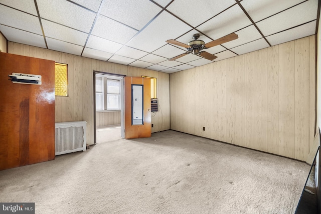 unfurnished room with carpet floors, ceiling fan, and a drop ceiling
