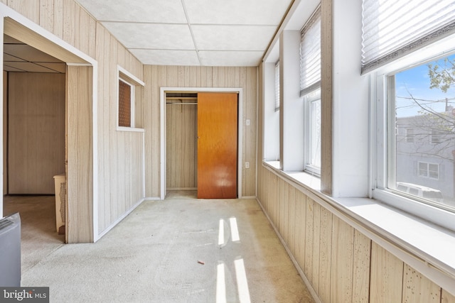 hall with light colored carpet