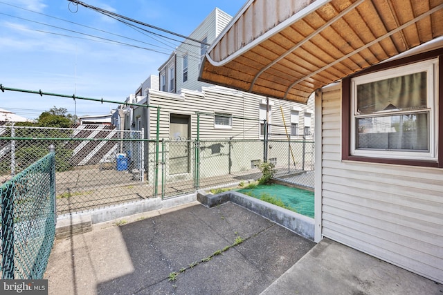 view of patio featuring fence and a gate