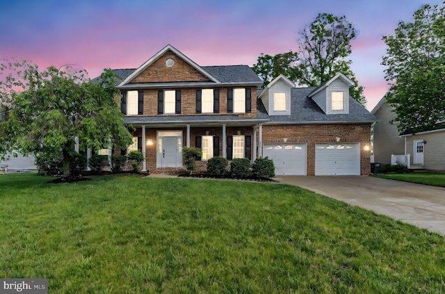 view of front of property with concrete driveway, a garage, brick siding, and a front lawn